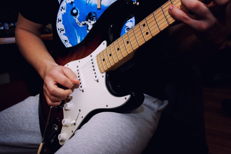 Man Performing Guitar